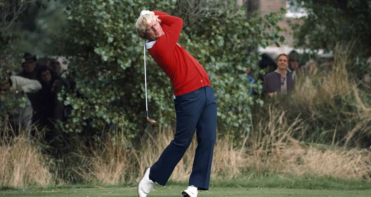 Jack in a red cardigan at the top of his follow-through, the gold numeral 18 overlaid.