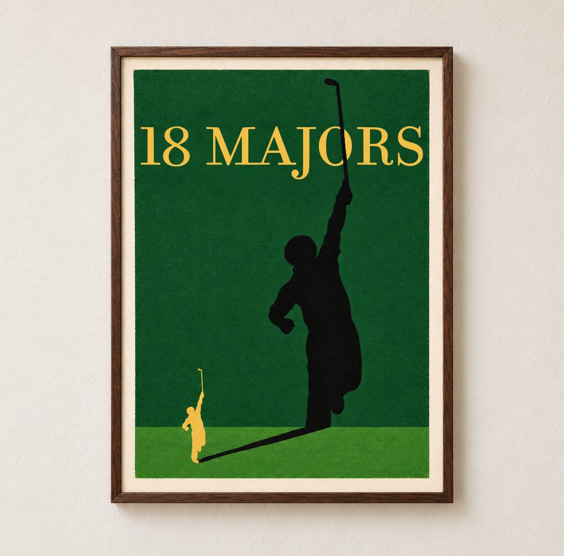 An oversized framed 18 Majors artwork, green ground with the gold name, the gold golfer casting the tall black shadow silhouette.