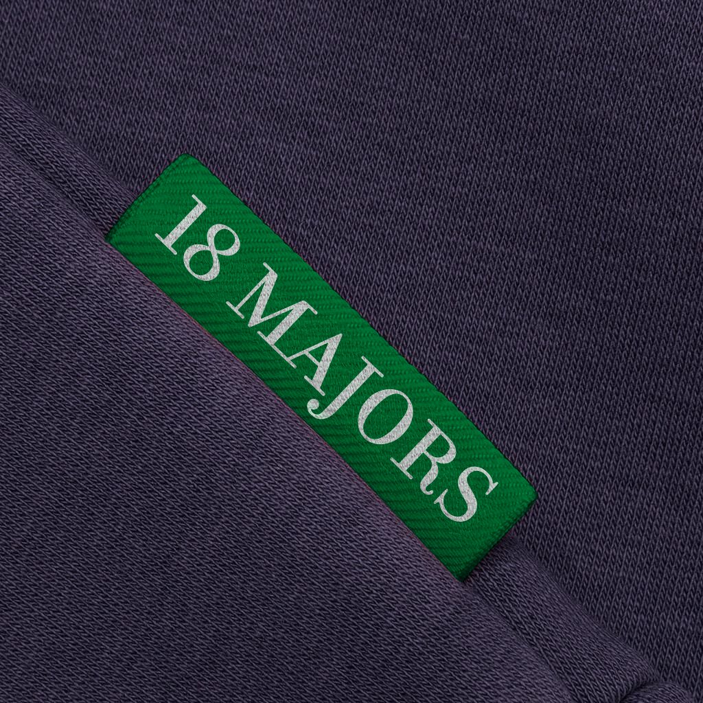 A green 18 Majors brand tag set into a navy seam.