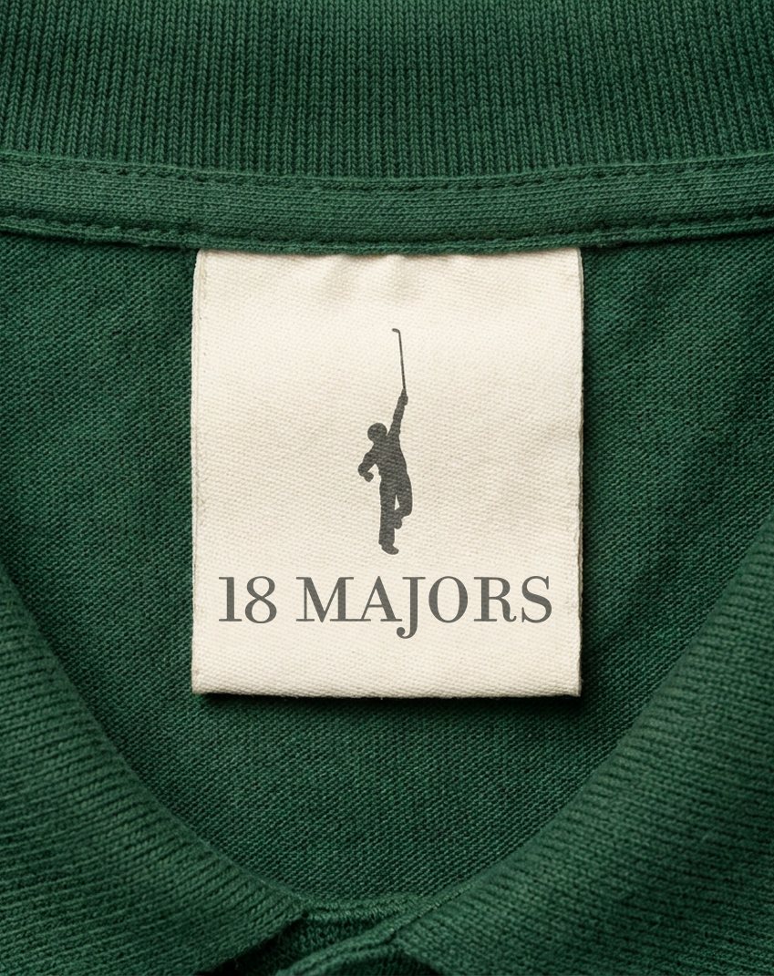A cream woven 18 Majors label stitched inside the collar of a green piqué polo.